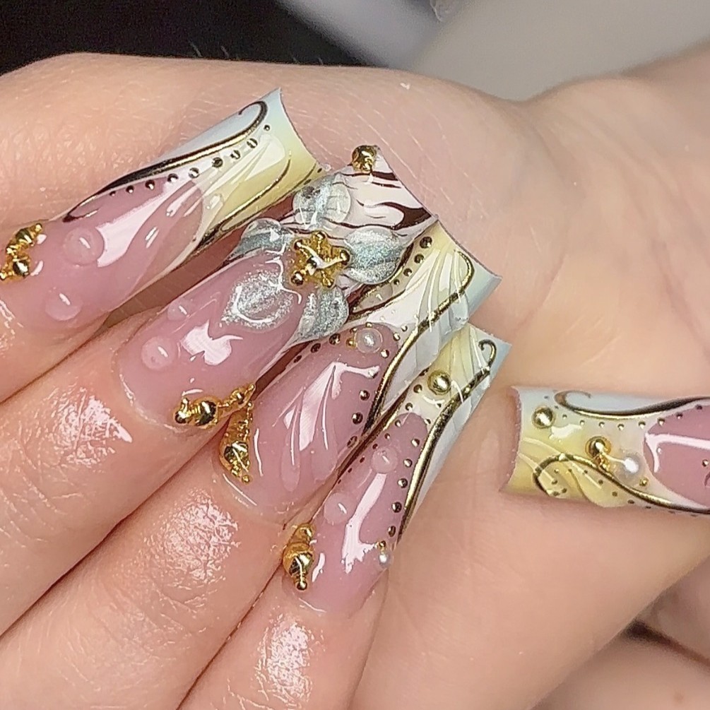 Extra-extra-long tapered square Gel-X nails with 3D white floral details, gold accents, and abstract French tip designs by n4ilsbybellaa